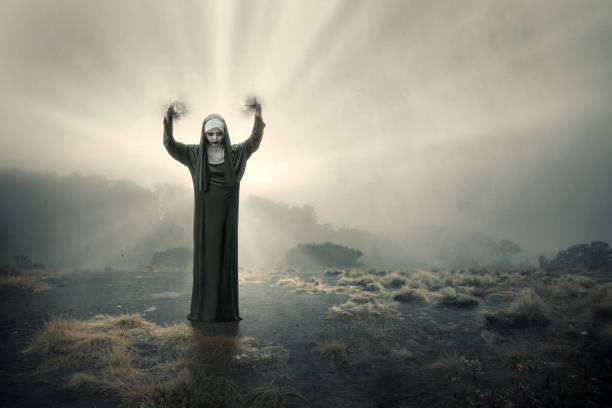 Scary devil nun standing Scary devil nun standing with a dramatic scene background angry nun stock pictures, royalty-free photos & images