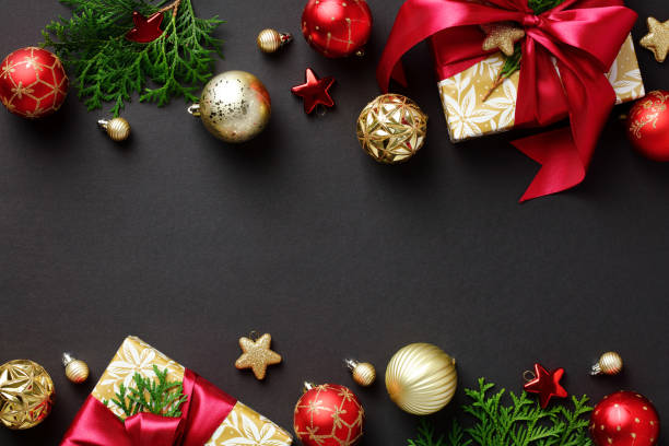 istock Christmas frame. Black Xmas background with gift boxes, gold baubles, Christmas tree branches. Flat lay, top view, copy space. 1433079707
