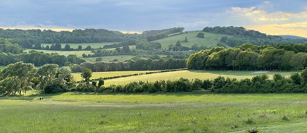 An aerial view of rural green areas under a sunny sky in England