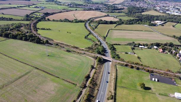 istock Drone view of an overpass road surrounded by green fields on a sunny day 1433080046