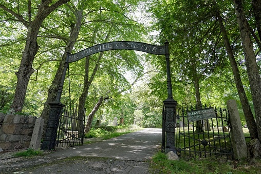 The old gate of Brookside Cemetery on a sunny day in Mount Desert, Maine