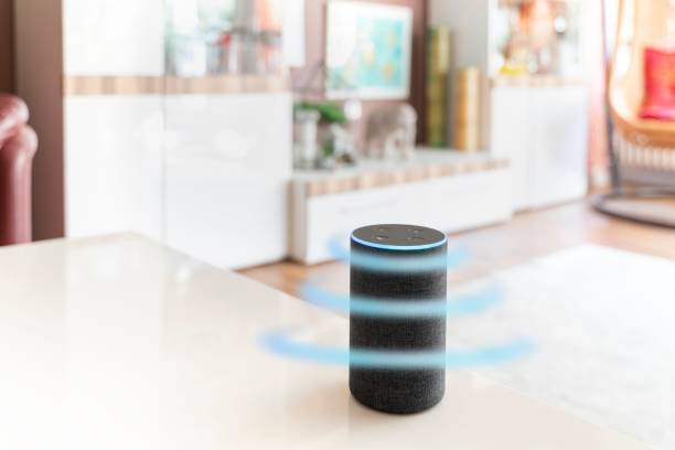 istock Closeup of a smart assistant on a table with light blue glowing. 1433081193