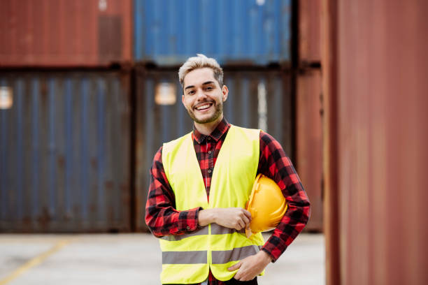istock young man loading goods from the dock, young worker in the logistics port. 1433081227
