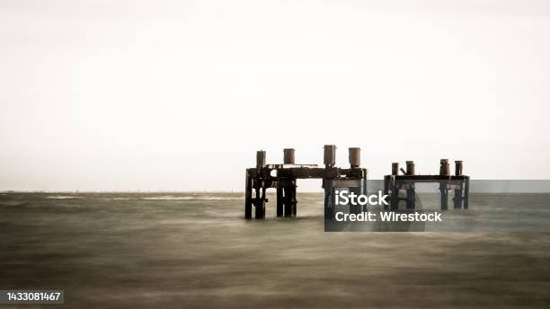Wooden Sea Dock Remains In The Ocean Of Calshot Beach Calshot England Uk Stock Photo - Download Image Now