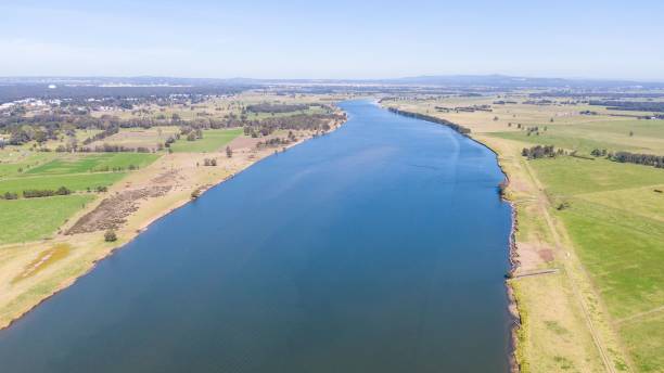 istock Riverbed and agricultural, green fields, aerial 1433084327