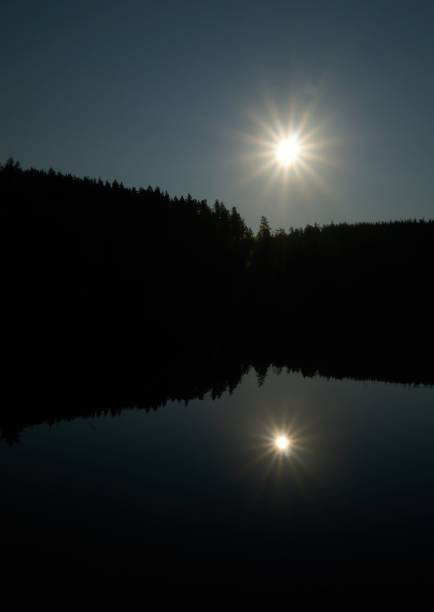 istock Beautiful view of a reflective lake surrounded by trees during sunrise 1433084884