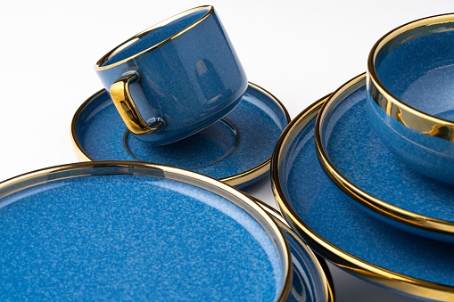 A Set of blue ceramic plates and cup on a white background