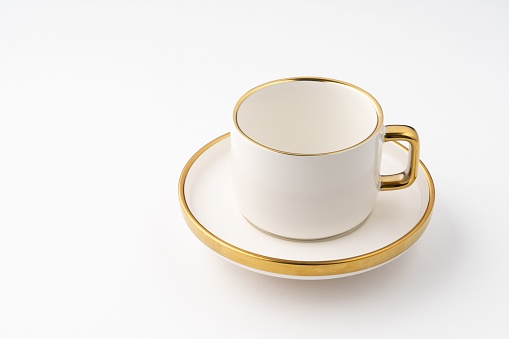 A Set of white and brown ceramic plate and cup on a white background