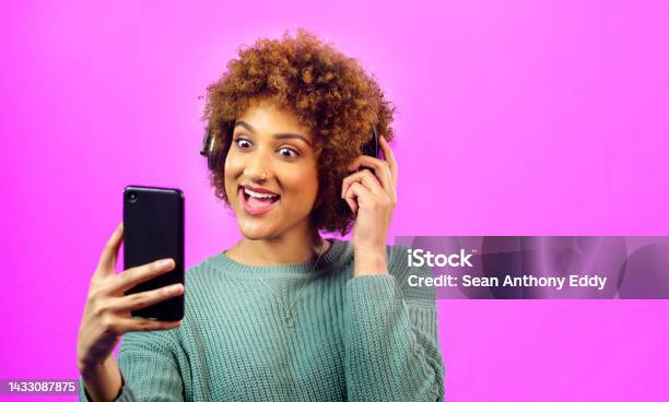 Woman With Phone In Hand And Headphones On Afro Surprise Smile For Video Call Or Good News Via The Internet Young Lady With Earphones Hair Curly Excited By Social Media Or Music On Smartphone Stock Photo - Download Image Now