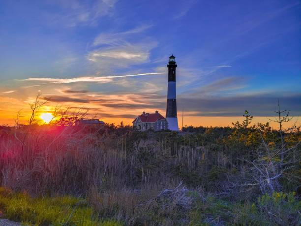 istock Lighthouse in a forest during a colorful sunset 1433089659