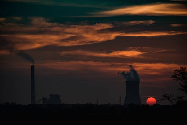 istock Beautiful sunset over the smoking nuclear power plant. 1433091898