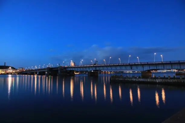 Photo of Beautiful evening view of Limfjordsbroen bridge over Limfjord in Aalborg, Denmark