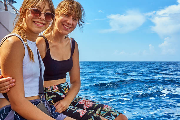 Sailing sisters on a sailing yacht in the Adriatic Sea sleeveless top stock pictures, royalty-free photos & images