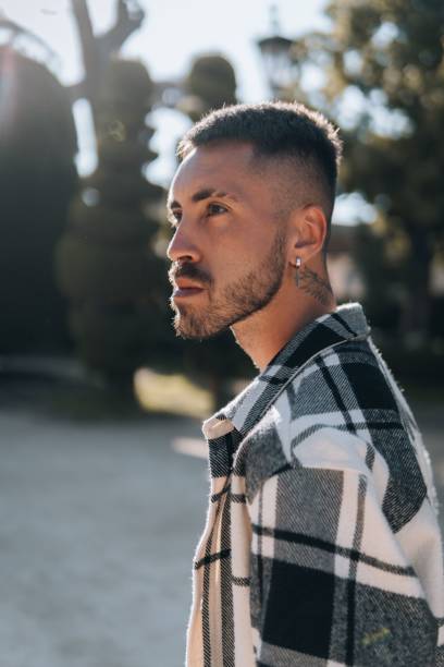istock Vertical of handsome pierced and tattooed caucasian man's profile. 1433094832