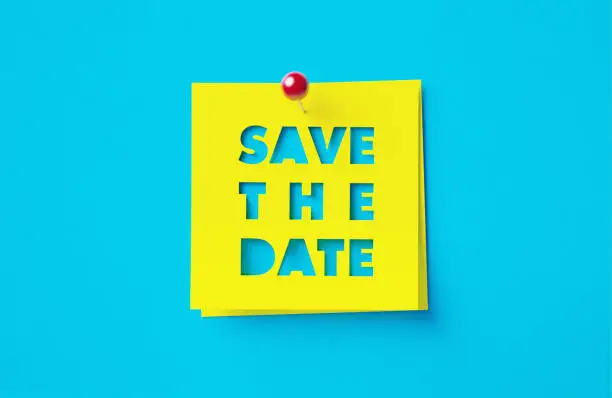 Photo of Save The Date Written Cut Out Yellow Adhesive Notes Sitting Over Blue Background