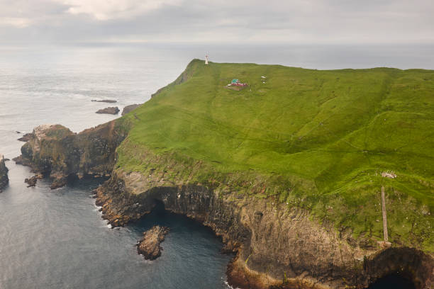 istock Mykines island lighthouse and cliffs on Faroe coastline from helicopter 1433096049