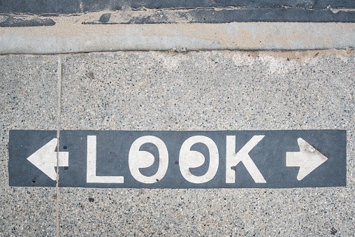 A Look marked sign on the ground at the crosswalk