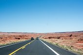 Highway road through a red-sand desert in Utah