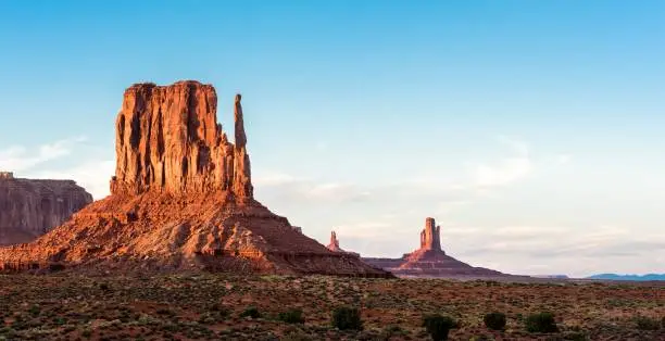 The red-sand deserted Monument Valley at Utah-Arizona line at sunset