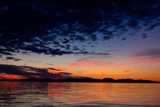 istock Mesmerizing view of a sunset over the ocean with calm waves 1433097394