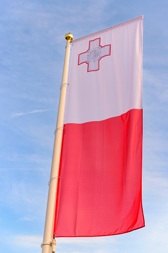 Vertical national flag of Malta waving in the wind