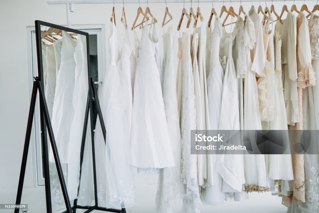 Bridal gown dressing room Hanger for bride in Bridal gown dressing room and a large mirror is located inside the room Wedding Dress Stock Photo