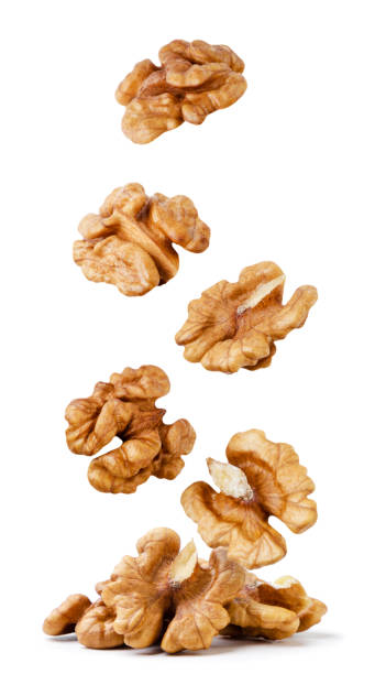 istock Walnut falls on a pile close-up on a white background. Isolated 1433099028