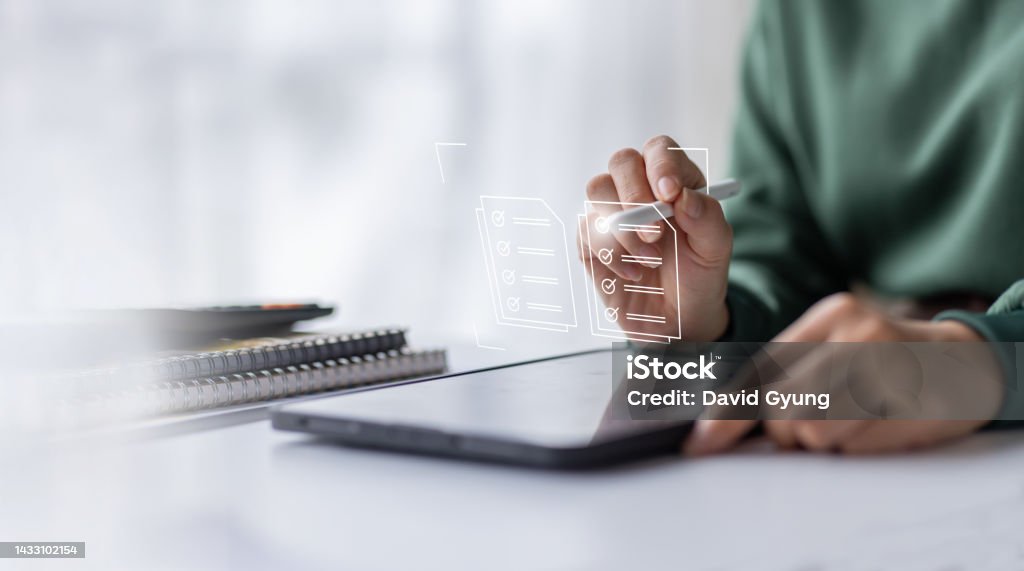 Businesswoman working on a laptop computer to document management online documentation database digital file storage system software records keeping database technology file access doc sharing. Calendar Date Stock Photo