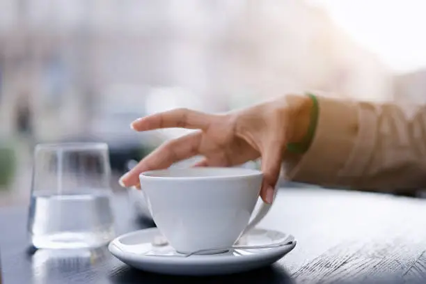 Photo of Coffee cup on table at street cafe