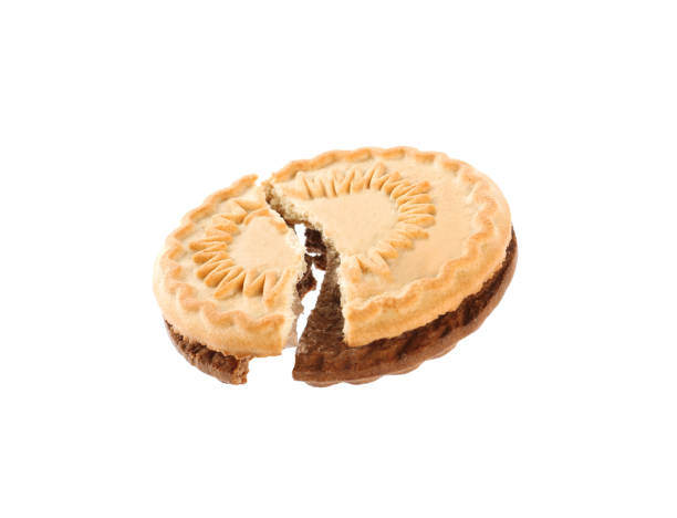 istock Broken tasty sandwich cookie with cream on white background 1433104087