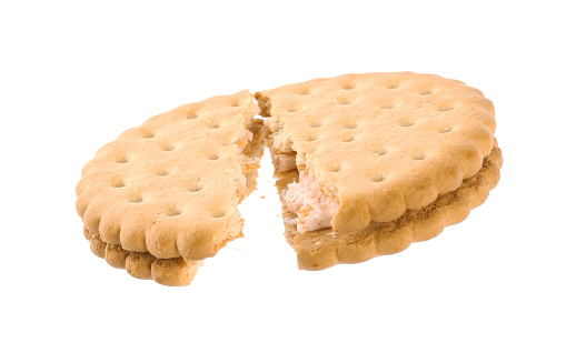 Broken tasty sandwich cookie with cream on white background