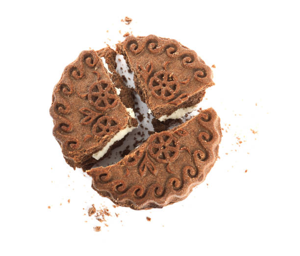istock Broken tasty chocolate sandwich cookie with cream on white background, top view 1433104189
