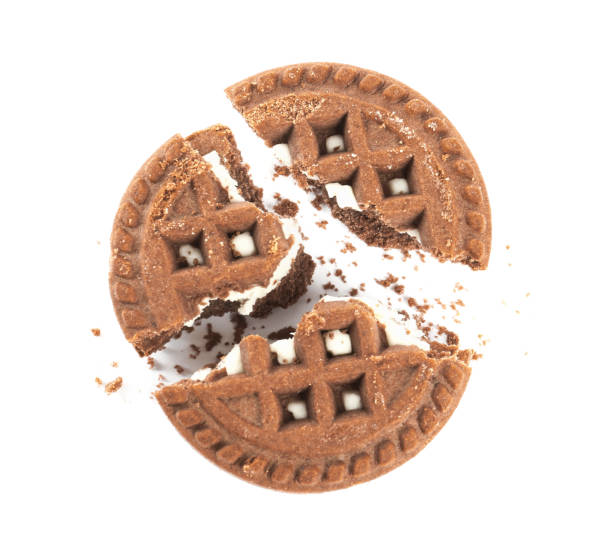 istock Broken tasty chocolate sandwich cookie with cream on white background, top view 1433104209