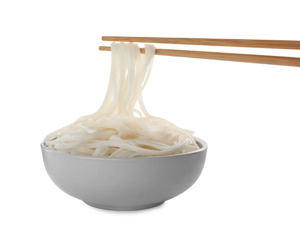 istock Taking rice noodles with chopsticks from bowl on white background 1433104271