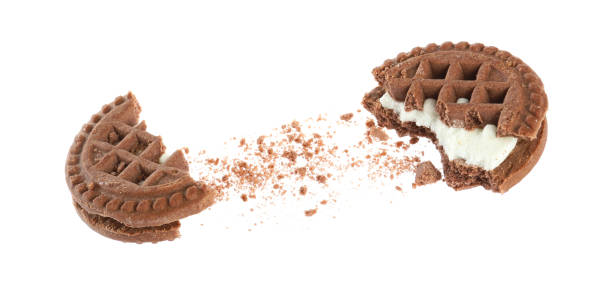 Broken tasty chocolate sandwich cookie with cream on white background