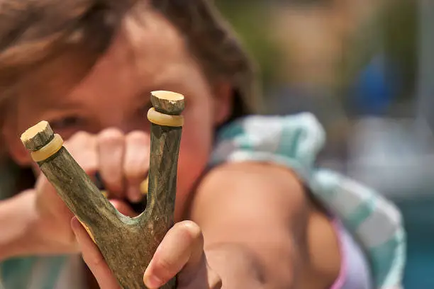 young girl with slingshot