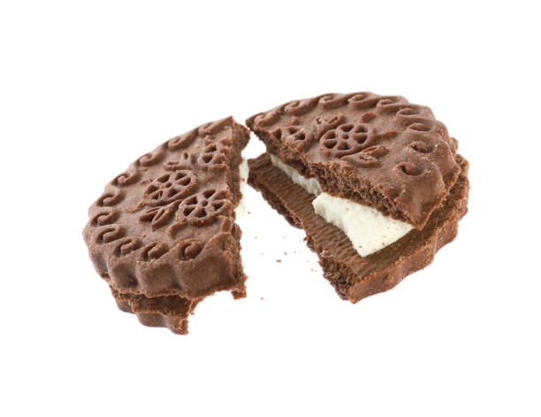 istock Broken tasty chocolate sandwich cookie with cream on white background 1433104886