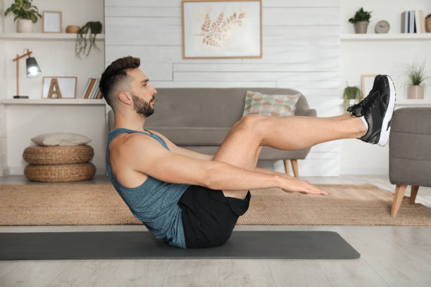 istock Handsome man doing abs exercise on yoga mat at home 1433105912
