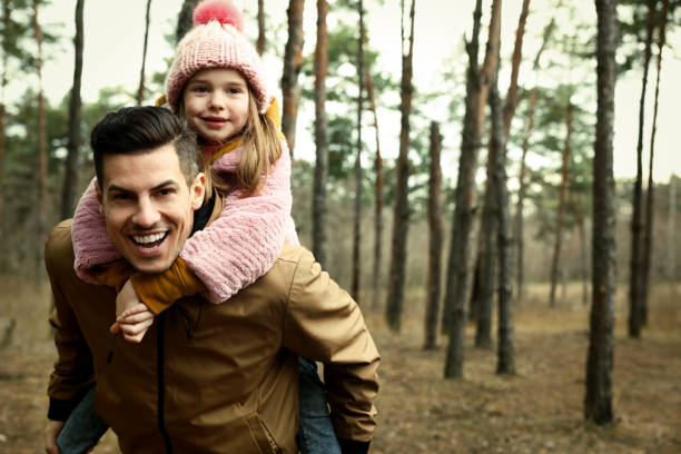 istock Man and his daughter spending time together in forest 1433107789
