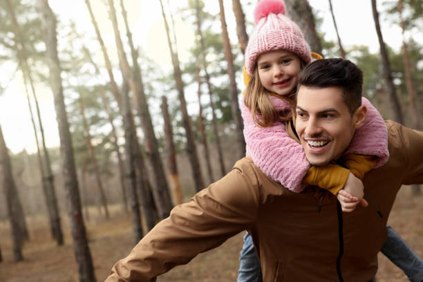 istock Man and his daughter spending time together in forest 1433107970