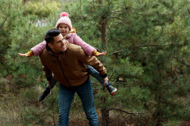istock Man and his daughter spending time together in forest 1433108000