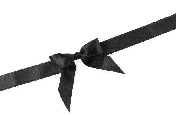 istock Black satin ribbon with bow on white background, top view 1433110123