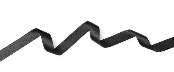 Black satin ribbon on white background, top view