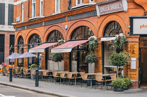 London, UK - September 1, 2022: Outdoor tables of Plants restaurant by Deliciously Ella in Mayfair, an affluent area in the West End of London in the City of Westminster borough.