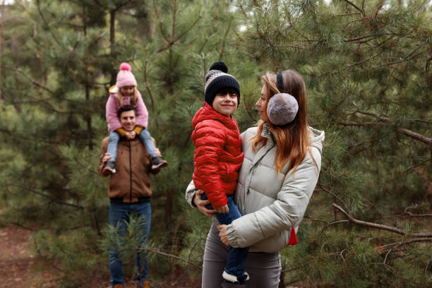 istock Happy family spending time together in forest 1433110501