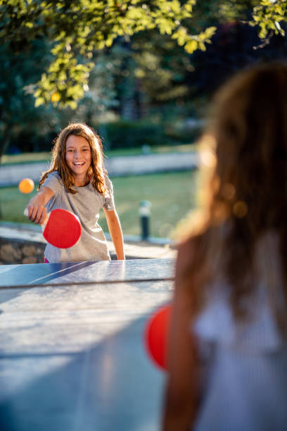 istock Girls playing table tennis on summer day 1433110563