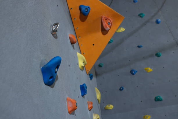 istock Climbing wall with holds in gym, low angle view. Extreme sport 1433111549