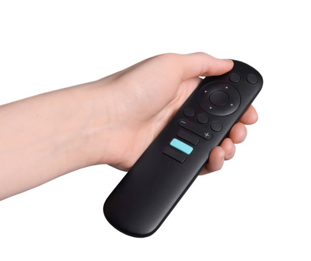 istock Woman holding TV remote control on grey background, closeup. Space for text 1433111594