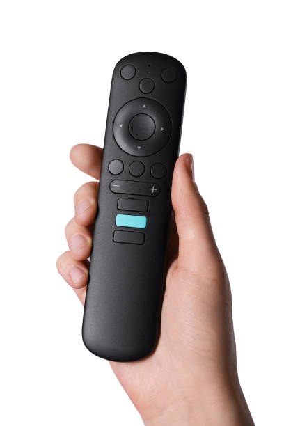 istock Woman holding TV remote control on grey background, closeup 1433111595
