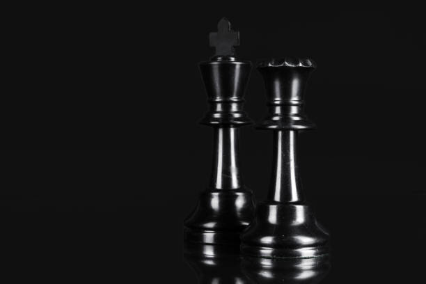 Chess piece close up on black background. Leadership concept